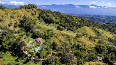 an aerial view of a house on a hill at Finca Mango - 40 acre paradise in Roble