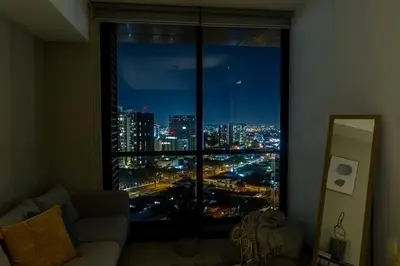 a room with a large window with a view of a city at Rooftop - 18th Floor Apt City View in Mata de Palo