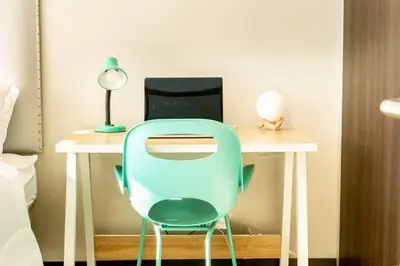 a desk with a blue chair and a laptop at Rooftop - 18th Floor Apt City View in Mata de Palo