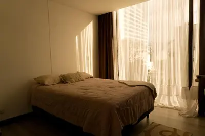 a bedroom with a bed and a large window at Rooftop - 18th Floor Apt City View in Mata de Palo