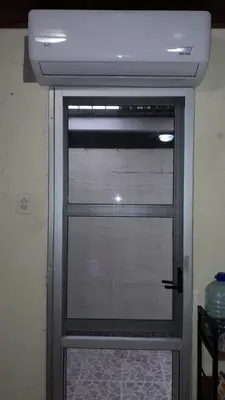 a glass door with a window in a room at Casa Mora in Jacó