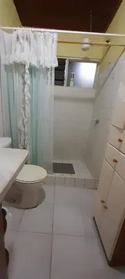 a bathroom with a toilet and a shower and a sink at Casa Mora in Jacó