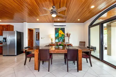 a kitchen and dining room with a ceiling fan at Casa Antonelli 4br Infinity Pool Pet Friendly in Playa Hermosa
