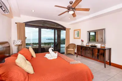 a bedroom with a large bed with a swan on it at Casa Antonelli 4br Infinity Pool Pet Friendly in Playa Hermosa