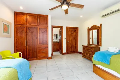 a bedroom with two beds and a ceiling fan at Casa Antonelli 4br Infinity Pool Pet Friendly in Playa Hermosa