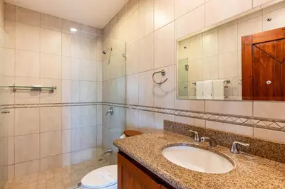 a bathroom with a sink and a toilet and a mirror at Casa Antonelli 4br Infinity Pool Pet Friendly in Playa Hermosa