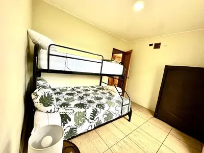 a bedroom with two bunk beds in a room at Oasis Arenal Villa Pool & Arenal Volcano View in Fortuna