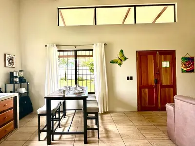 a dining room with a table and a butterfly on the ceiling at Oasis Arenal Villa Pool & Arenal Volcano View in Fortuna