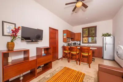 a kitchen with a refrigerator and a table with chairs at Apartamento Del Mar in Playa Flamingo