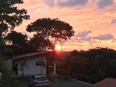 a car parked in front of a house with the sunset at Villas Lambeau #2 Ocean View Fiber Optic in Uvita