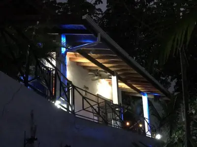 a house with blue lights on top of it at night at Villas Lambeau #2 Ocean View Fiber Optic in Uvita
