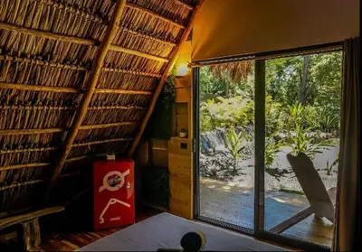 a room with a window and a view of a yard at Cabinas de Lou Eco Lodge TAMARINDO do not book, under maintenance in Santa Rosa