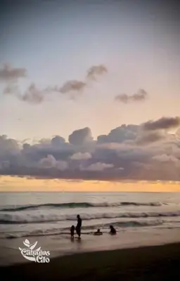 a group of people on the beach at sunset at Casita Verde, 800 mts from beach in Playa Hermosa