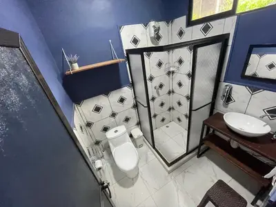 a bathroom with a toilet and a sink at POSADA MIRADIA in Matapalo