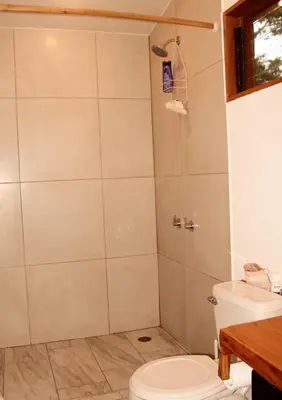 a bathroom with a shower with a toilet and a sink at Casa Por Fin in Monteverde Costa Rica