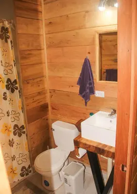 a bathroom with a toilet and a sink at Casa Por Fin in Monteverde Costa Rica