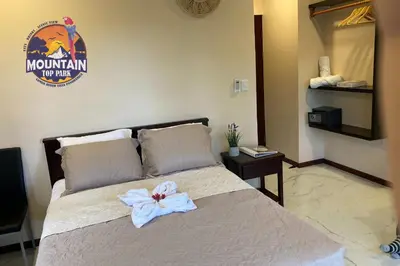 a bedroom with a bed with a white bow on it at Mountain Top Park Hotel in Manuel Antonio