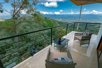 a balcony with a view of the mountains at Mountain Top Park Hotel in Manuel Antonio