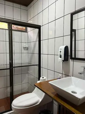 a bathroom with a sink and a toilet and a mirror at Hotel y Restaurante El Páramo in San Rafael Norte