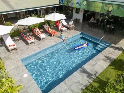 an overhead view of a pool with people playing in it at Apartments Nauyaca in Platanillo