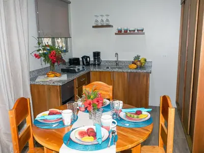 a table with plates of fruit on it in a kitchen at Apartments Nauyaca in Platanillo