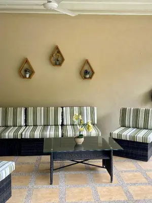 a living room with two couches and a coffee table at Holiday Beach House In Punta Leona - wprivate Pool in Punta Leona