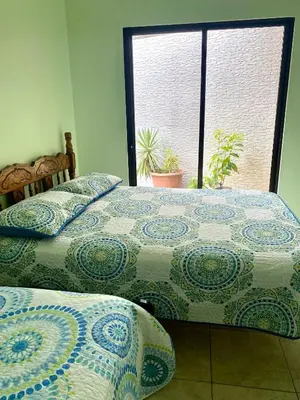 two twin beds in a room with a window at Holiday Beach House In Punta Leona - wprivate Pool in Punta Leona