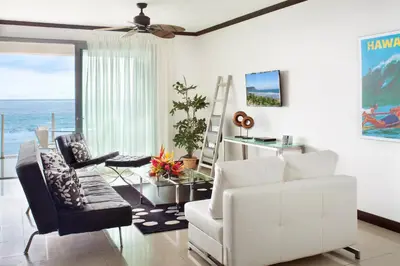 a living room with a white couch and a table at Best in Jaco Condos at Diamante del Sol in Jacó