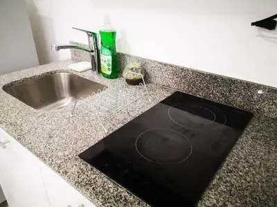 a kitchen counter with a sink and a bottle of soap at 0201 iFreses Hermoso Apartamento Full Equipado SIN PARQUEO in Curridabat