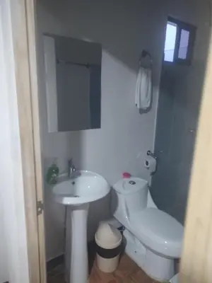 a bathroom with a sink and a toilet and a mirror at Cabinas equipadas Cóbano - Florida in Tambor