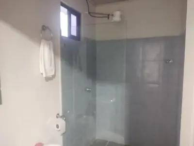 a bathroom with a shower with a glass door at Cabinas equipadas Cóbano - Florida in Tambor