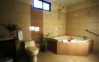 a bathroom with a tub and a toilet and a sink at B&B Garden Grecia in Grecia