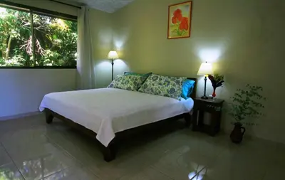 a bedroom with a bed with two lamps and a window at B&B Garden Grecia in Grecia