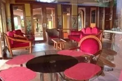 a room with pink chairs and a table in a train at Lake Arenal Killer View Villa in Tilarán