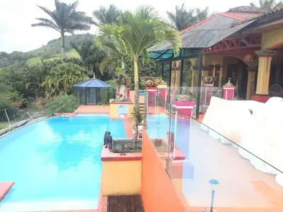 a large swimming pool next to a resort at Lake Arenal Killer View Villa in Tilarán