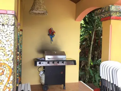 a kitchen with a stove with a bird on the wall at Lake Arenal Killer View Villa in Tilarán