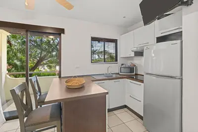 a kitchen with white cabinets and a white refrigerator at Beautiful beach front entire condo in Coco