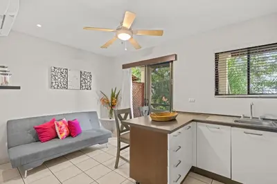 a kitchen and living room with a couch and a ceiling fan at Beautiful beach front entire condo in Coco