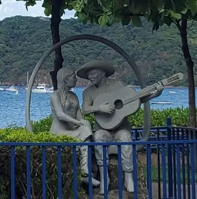 a statue of a man and a woman playing a guitar at Beautiful beach front entire condo in Coco