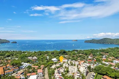 an aerial view of a city and the ocean at Beautiful beach front entire condo in Coco