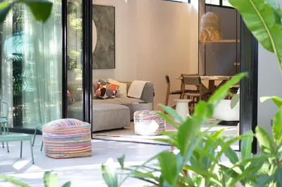a living room with a couch and a table at D'Palm Villas in Puntarenas