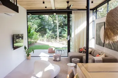 a living room with a couch and a table at D'Palm Villas in Puntarenas
