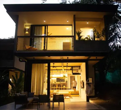 a house with a balcony and a living room at D'Palm Villas in Puntarenas