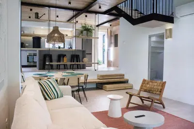 a living room with a couch and a table at D'Palm Villas in Puntarenas