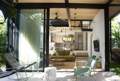 a living room with chairs and a couch at D'Palm Villas in Puntarenas