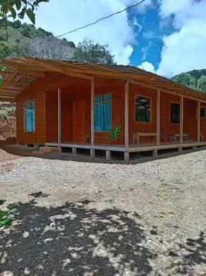 a small wooden house with a large porch at Cabaña Paraíso Verde in Providencia