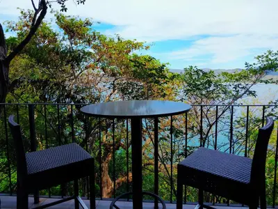 a table and two chairs on a balcony with a view at 360 Splendor - Ocean-View Condo #204 in Luxury Flamingo-Complex in Playa Flamingo