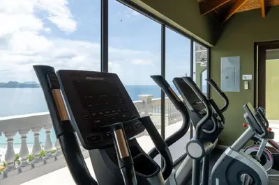 a gym with cardio machines and a view of the ocean at 360 Splendor - Ocean-View Condo #204 in Luxury Flamingo-Complex in Playa Flamingo