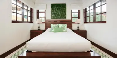 a bedroom with a large white bed and windows at Casa Cazenovia - 3BR home, astonishing rooftop terrace in Las Catalinas in Playa Danta