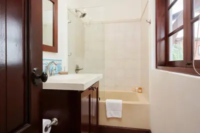 a bathroom with a sink and a tub and a mirror at Casa Cazenovia - 3BR home, astonishing rooftop terrace in Las Catalinas in Playa Danta